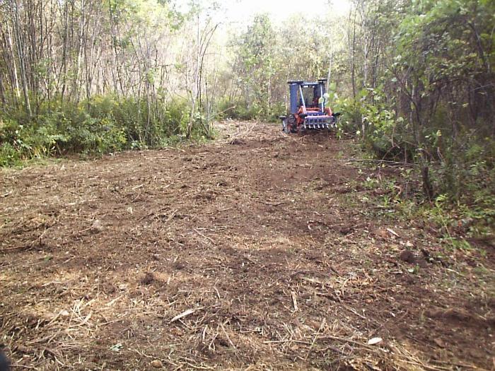 Repeated passes of the trail building machine shred brush and limbs into a mulch that is incorporated into the trail surface.
